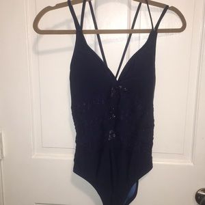 One piece bathing suit with mesh inserts.